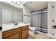 Bathroom featuring a vanity, toilet, shower and tub combination with blue and white curtain at 373 Fischer Rd, Fort Mill, SC 29715