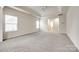 Spacious carpeted bedroom with neutral walls, a ceiling fan and natural light from large windows at 373 Fischer Rd, Fort Mill, SC 29715