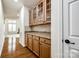 Butler's pantry with granite countertops, wooden cabinets, and tile backsplash at 373 Fischer Rd, Fort Mill, SC 29715