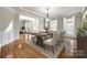 Elegant dining room with hardwood floors, white chairs, and a decorative chandelier at 373 Fischer Rd, Fort Mill, SC 29715