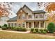 Charming two-story home with a stone and siding facade, complemented by manicured landscaping at 373 Fischer Rd, Fort Mill, SC 29715