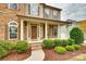 Inviting front porch with stone steps, columns, and lush landscaping offering curb appeal at 373 Fischer Rd, Fort Mill, SC 29715