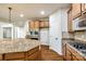 Bright kitchen features wood floors, light-brown cabinets, granite counters, backsplash and stainless steel appliances at 373 Fischer Rd, Fort Mill, SC 29715