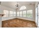 Bright living room features wood floors, arched window, chandelier and large windows with natural light at 373 Fischer Rd, Fort Mill, SC 29715