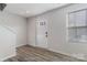 Bright and airy entryway with wood-look floors and modern door at 5117 Tinker Field Rd, Charlotte, NC 28215