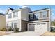 Two-story house with gray and beige siding, a two-car garage, and a landscaped lawn at 5117 Tinker Field Rd, Charlotte, NC 28215