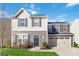 Two-story house with gray and beige siding, a two-car garage, and a landscaped lawn at 5117 Tinker Field Rd, Charlotte, NC 28215