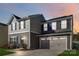 Two-story house with gray and beige siding, a two-car garage, and a landscaped lawn at 5117 Tinker Field Rd, Charlotte, NC 28215