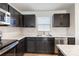 Modern kitchen with dark cabinets and stainless steel appliances at 5117 Tinker Field Rd, Charlotte, NC 28215