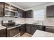 Modern kitchen with dark cabinets and stainless steel appliances at 5117 Tinker Field Rd, Charlotte, NC 28215