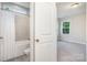 View from doorway to bathroom with shower/tub combination and tile surround, next to bedroom with natural light at 562 Shepherd Ln # 3, Clover, SC 29710