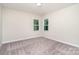 Bedroom featuring neutral carpet and paint, natural light, and views of the neighboring homes at 562 Shepherd Ln # 3, Clover, SC 29710