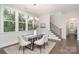 Bright dining room with a modern chandelier, large windows, and stairs to upper level at 562 Shepherd Ln # 3, Clover, SC 29710