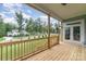 View from spacious covered porch showing wood decking, railing, and view of the surrounding neighborhood at 562 Shepherd Ln # 3, Clover, SC 29710