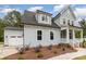 Charming two-story home with a light blue exterior, a white garage door, and a well-manicured front yard at 562 Shepherd Ln, Clover, SC 29710