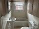 Bathroom with a bathtub, sink, and toilet at 614 Morven Rd, Wadesboro, NC 28170