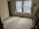 Simple bedroom with carpet and two windows at 614 Morven Rd, Wadesboro, NC 28170