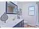 Updated bathroom with navy vanity, white countertop, and tiled shower at 816 Wellwood Ave, Statesville, NC 28677