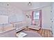 Charming Bedroom with crib, rocker, and leaf-patterned wall mural at 816 Wellwood Ave, Statesville, NC 28677