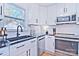 White kitchen with stainless steel appliances and black sink at 816 Wellwood Ave, Statesville, NC 28677