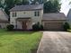 Two-story house with a red door, attached garage, and well-maintained lawn at 9618 Langston Mill Rd # 38, Charlotte, NC 28216