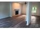 Spacious living room with fireplace and hardwood floors at 9618 Langston Mill Rd # 38, Charlotte, NC 28216