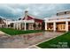 Community clubhouse with a red barn-style exterior and stone patio at 136 Chimney Rock Ct, Denver, NC 28037