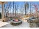 Stone fire pit with built in seating area at 136 Chimney Rock Ct, Denver, NC 28037