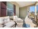 Relaxing front porch with wicker chairs and a side view of the garage at 136 Chimney Rock Ct, Denver, NC 28037