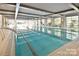 Indoor lap pool with large windows and plenty of natural light at 136 Chimney Rock Ct, Denver, NC 28037