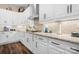 White kitchen with granite countertops and a tile backsplash at 136 Chimney Rock Ct, Denver, NC 28037