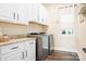 Convenient laundry room with washer, dryer, and cabinets at 136 Chimney Rock Ct, Denver, NC 28037