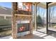 Screened porch with stone fireplace and TV at 136 Chimney Rock Ct, Denver, NC 28037