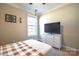 Bedroom includes a large window for natural light, a ceiling fan, and a neutral color scheme at 3877 Lake Breeze Dr, Sherrills Ford, NC 28673