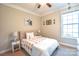 Cozy bedroom features a ceiling fan, side tables, and a large window that lets in natural light at 3877 Lake Breeze Dr, Sherrills Ford, NC 28673