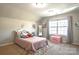 Bright bedroom featuring a comfortable bed, a window with natural light, and playful decor at 3877 Lake Breeze Dr, Sherrills Ford, NC 28673