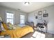 Bedroom featuring a desk area, light walls, two windows and carpeted floors at 3877 Lake Breeze Dr, Sherrills Ford, NC 28673