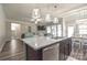 Spacious kitchen island has seating, granite countertops, a stainless steel dishwasher, and pendant lighting at 3877 Lake Breeze Dr, Sherrills Ford, NC 28673