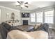 Comfortable living room featuring hardwood floors, a fireplace, and large windows for natural light at 3877 Lake Breeze Dr, Sherrills Ford, NC 28673