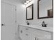 Double vanity bathroom with dark framed mirrors at 3907 E Lawyers Rd, Monroe, NC 28110