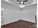 Simple bedroom with hardwood floors and ceiling fan at 3907 E Lawyers Rd, Monroe, NC 28110