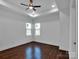 Well-lit bedroom with hardwood floors and a ceiling fan at 3907 E Lawyers Rd, Monroe, NC 28110