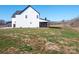 Two-story farmhouse showcasing rear elevation with covered porch at 3907 E Lawyers Rd, Monroe, NC 28110