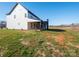 Two-story farmhouse showcasing rear elevation with covered porch at 3907 E Lawyers Rd, Monroe, NC 28110