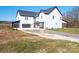 Two-story farmhouse showcasing side elevation with covered porch at 3907 E Lawyers Rd, Monroe, NC 28110