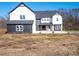 Two-story farmhouse with black and white exterior, attached garage, and landscaping at 3907 E Lawyers Rd, Monroe, NC 28110