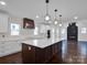 Modern kitchen with large island and dark cabinets at 3907 E Lawyers Rd, Monroe, NC 28110