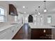 Modern kitchen with white cabinets, marble island, and dark wood accents at 3907 E Lawyers Rd, Monroe, NC 28110