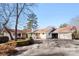 View of the back exterior showcasing the outdoor patio, grill and a spacious driveway leading to the garage at 946 Scotch Dr, Gastonia, NC 28054