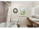 Bright bathroom featuring neutral decor, stylish vanity with trough sink and classic tile accents in the shower and bath at 946 Scotch Dr, Gastonia, NC 28054